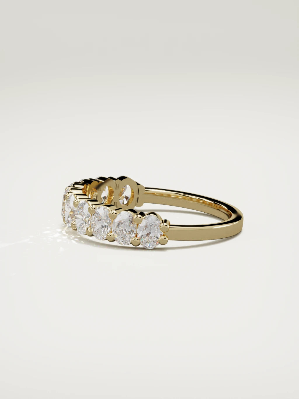 The Musa north-south oval half eternity band in 14K yellow gold, side view
