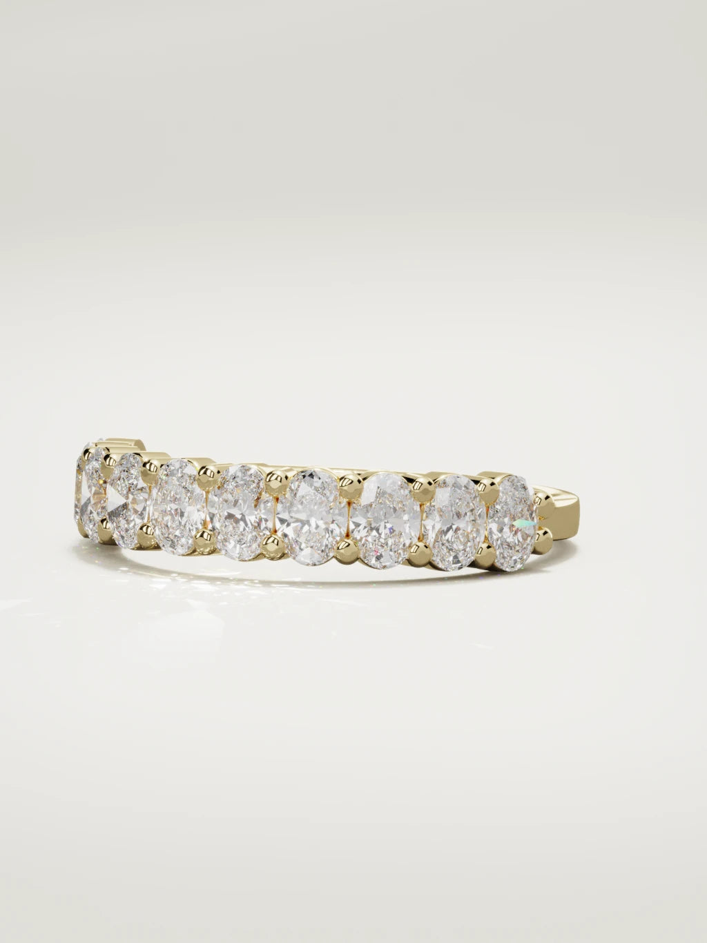 The Musa north-south oval half eternity band in 14K yellow gold, three-quarter view
