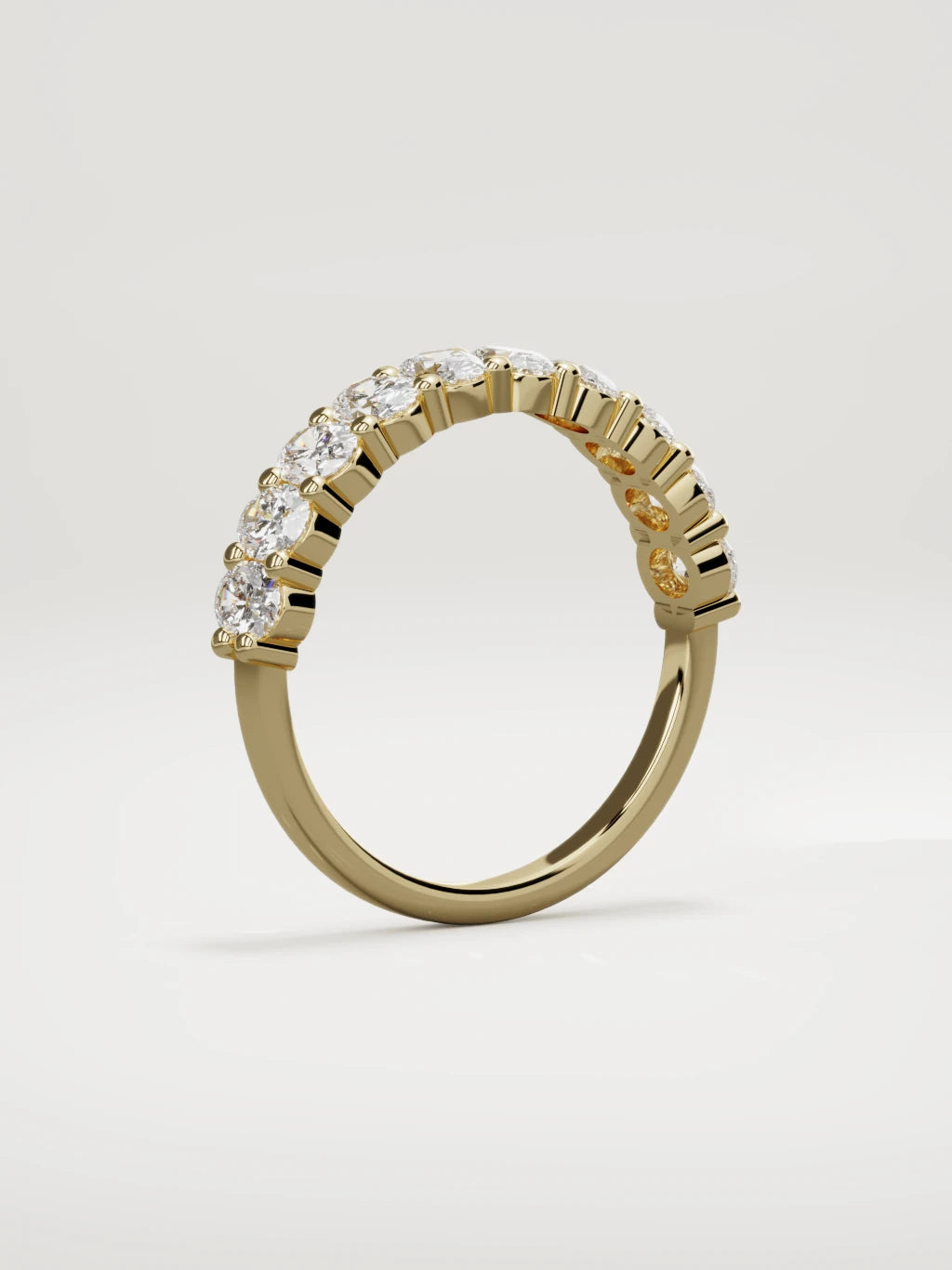 The Musa north-south oval half eternity band in 14K yellow gold, standing three-quarter view