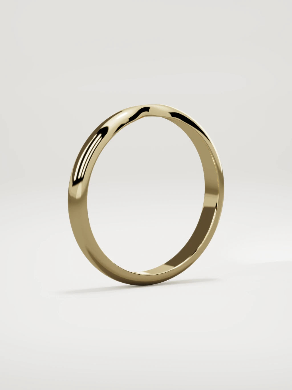 The Nido notched contour wedding band in 14K yellow gold, standing three-quarter view