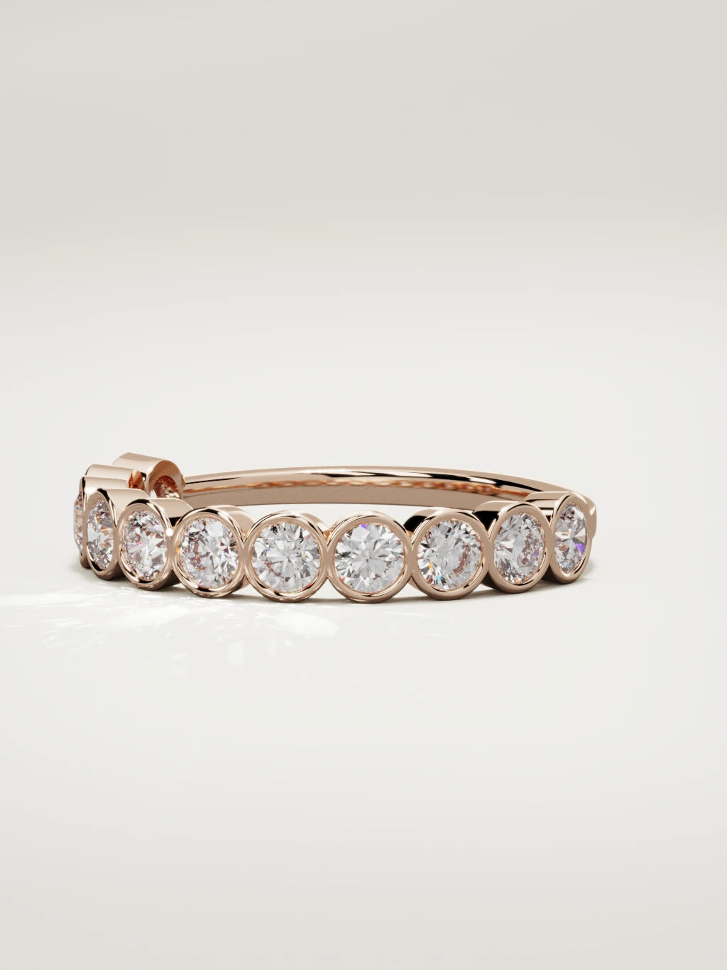 The Perla bezel bubble half eternity band in 14K rose gold, three-quarter view