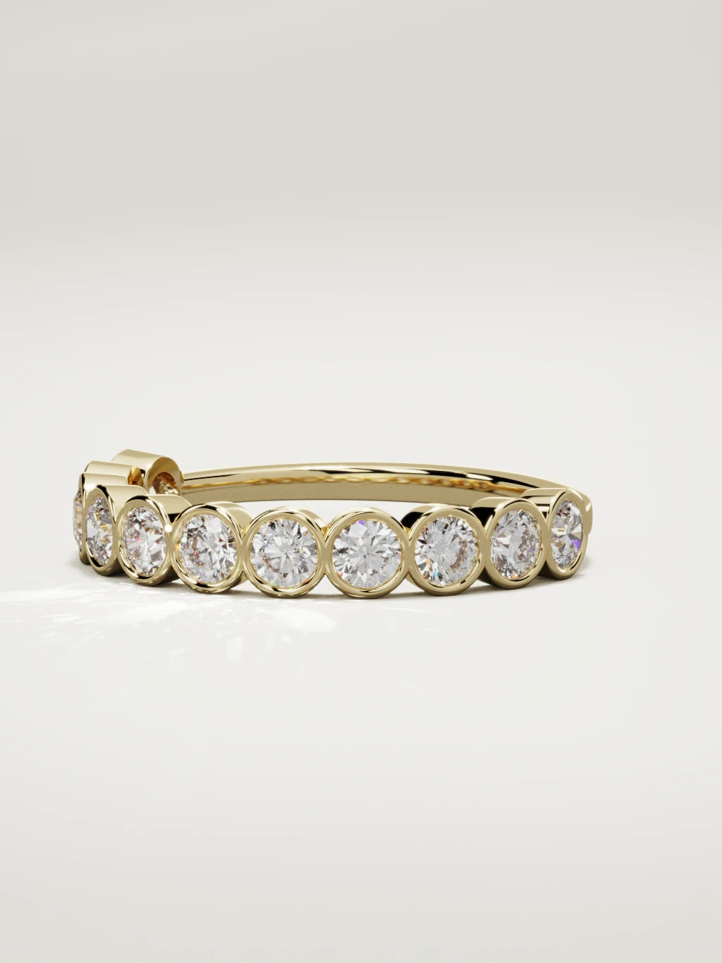 The Perla bezel bubble half eternity band in 14K yellow gold, three-quarter view