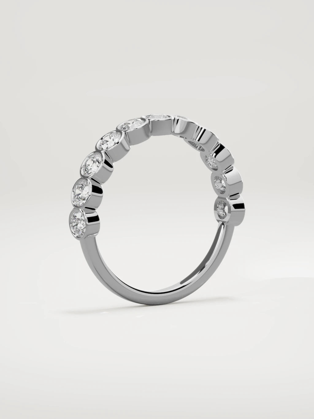 The Perla bezel bubble half eternity band in 14K white gold, standing three-quarter view