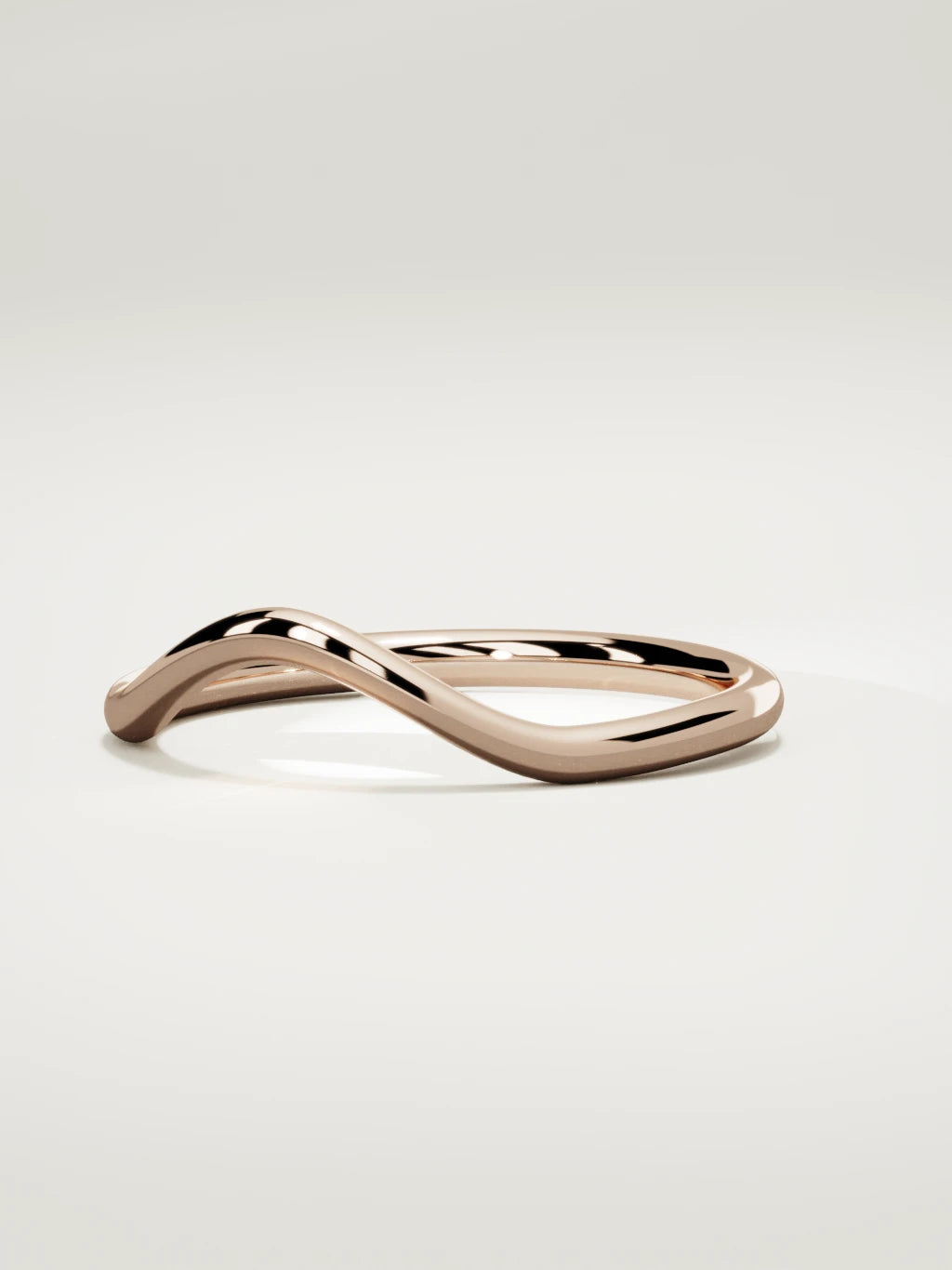 The Rima rounded contour wedding band in 14K rose gold, three-quarter view