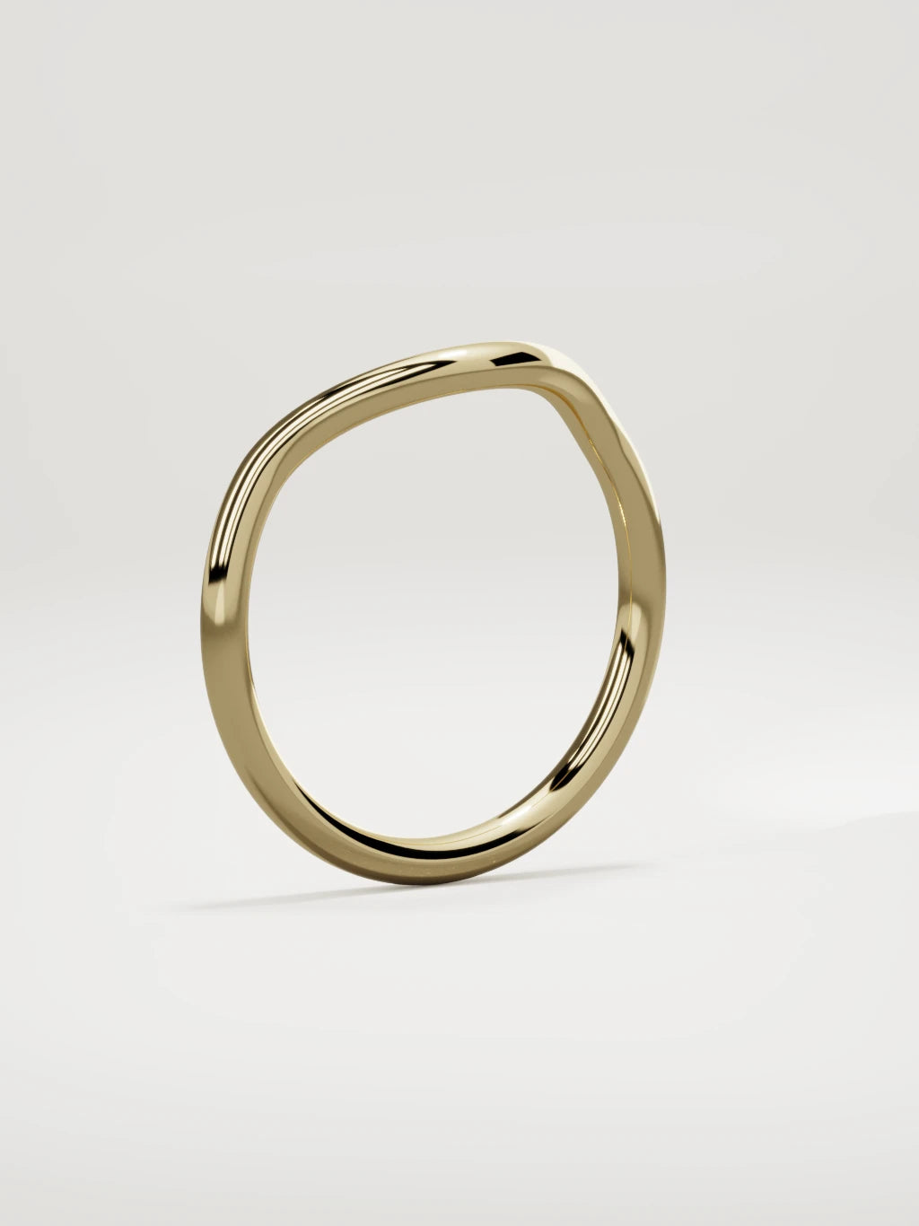 The Rima rounded contour wedding band in 14K yellow gold, standing three-quarter view