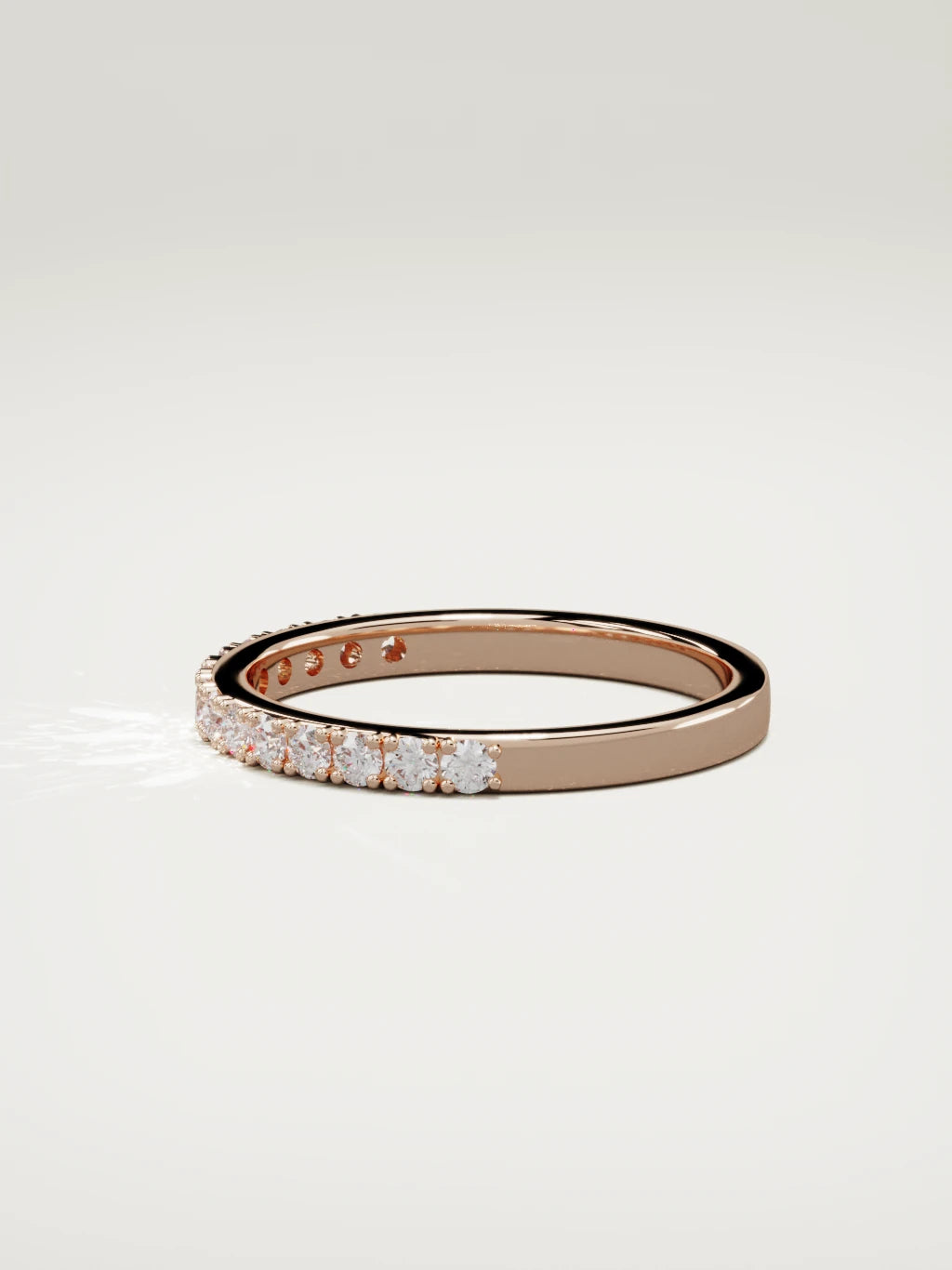 The Sutil low-profile petite half eternity band in 14K rose gold, side view