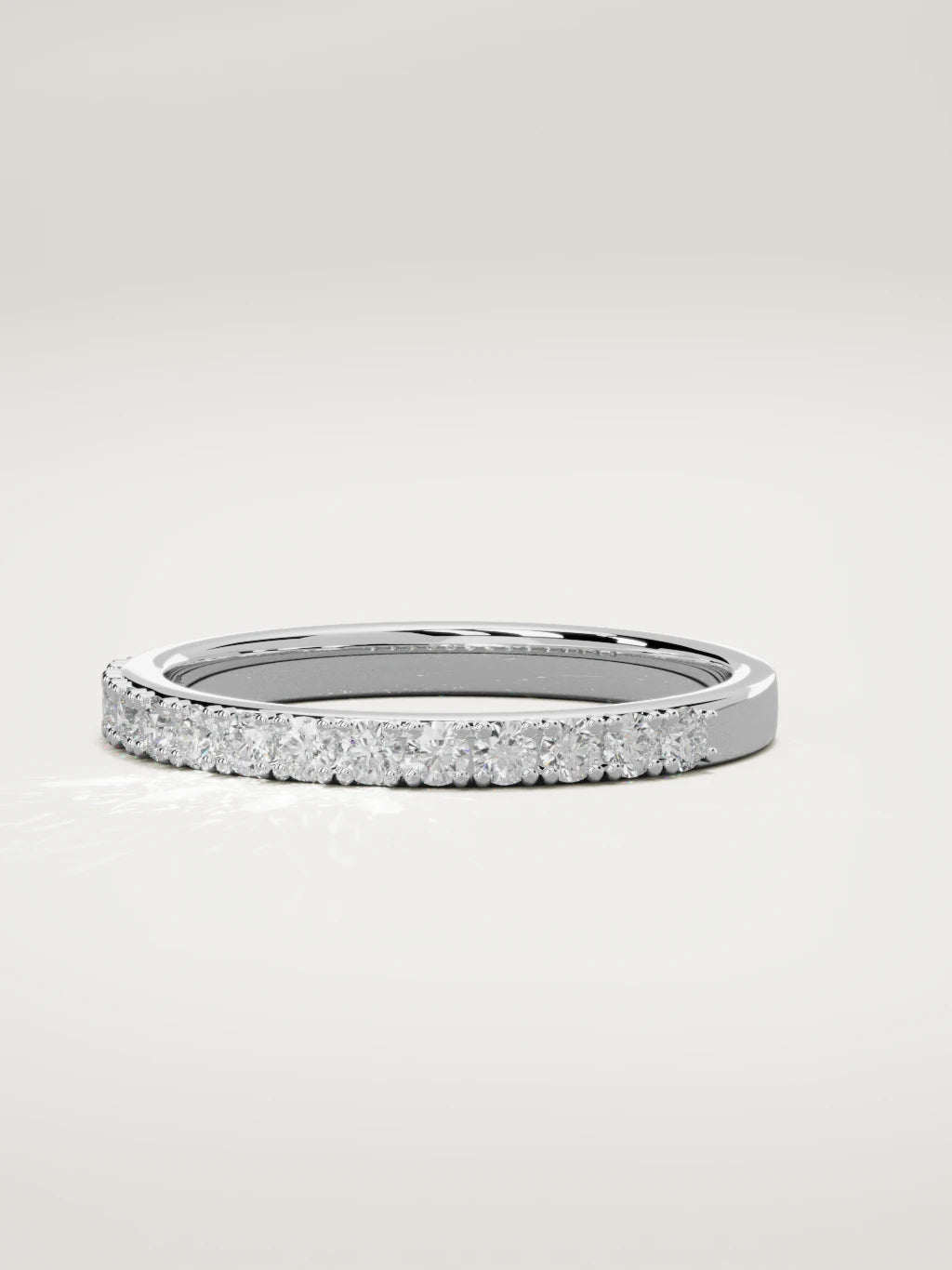 The Sutil low-profile petite half eternity band in 14K white gold, three-quarter view