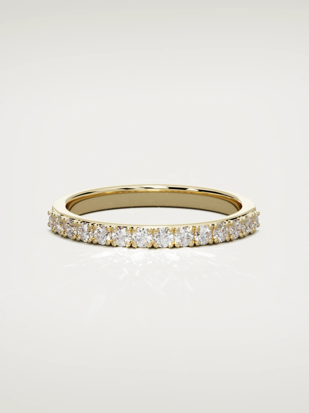 The Sutil low-profile petite half eternity band in 14K yellow gold, front view