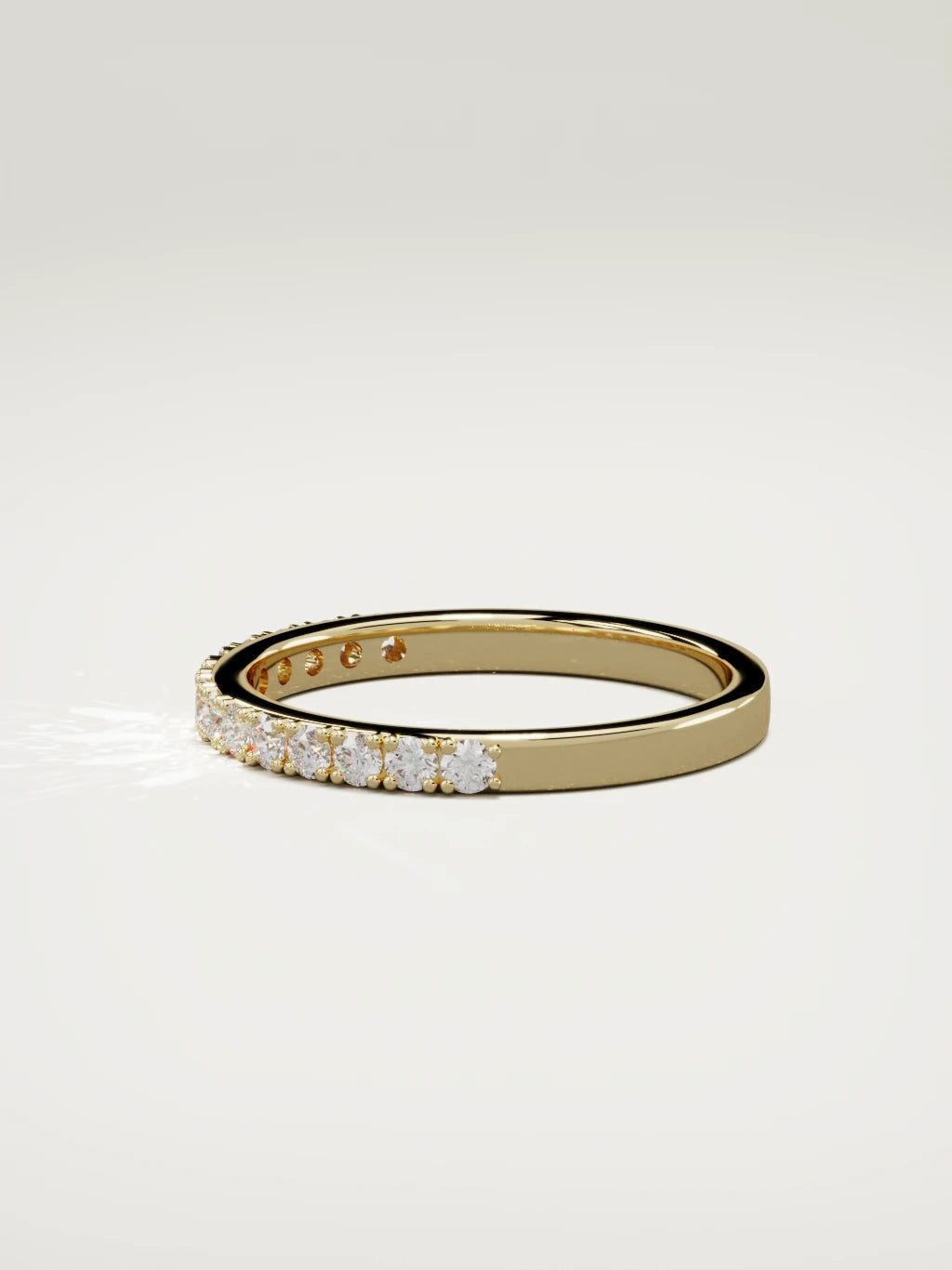 The Sutil low-profile petite half eternity band in 14K yellow gold, side view