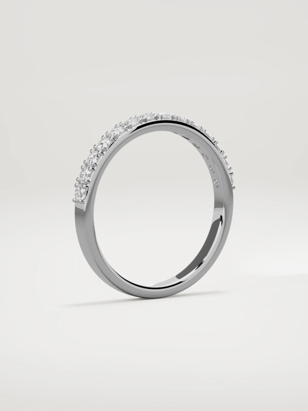 The Sutil low-profile petite half eternity band in 14K white gold, standing three-quarter view