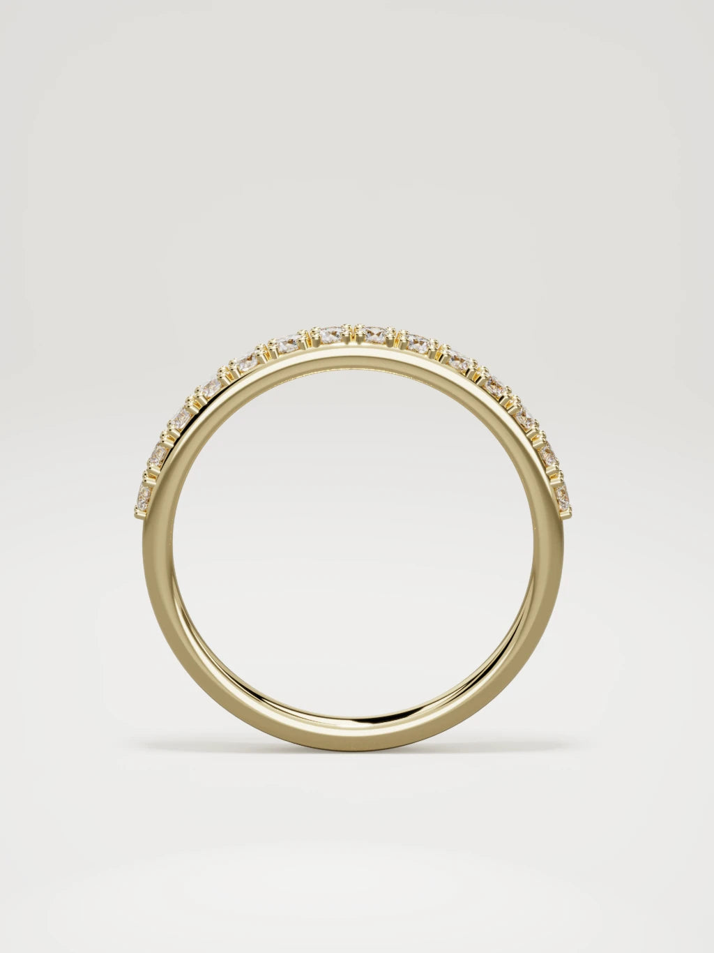 The Sutil low-profile petite half eternity band in 14K yellow gold, standing front view