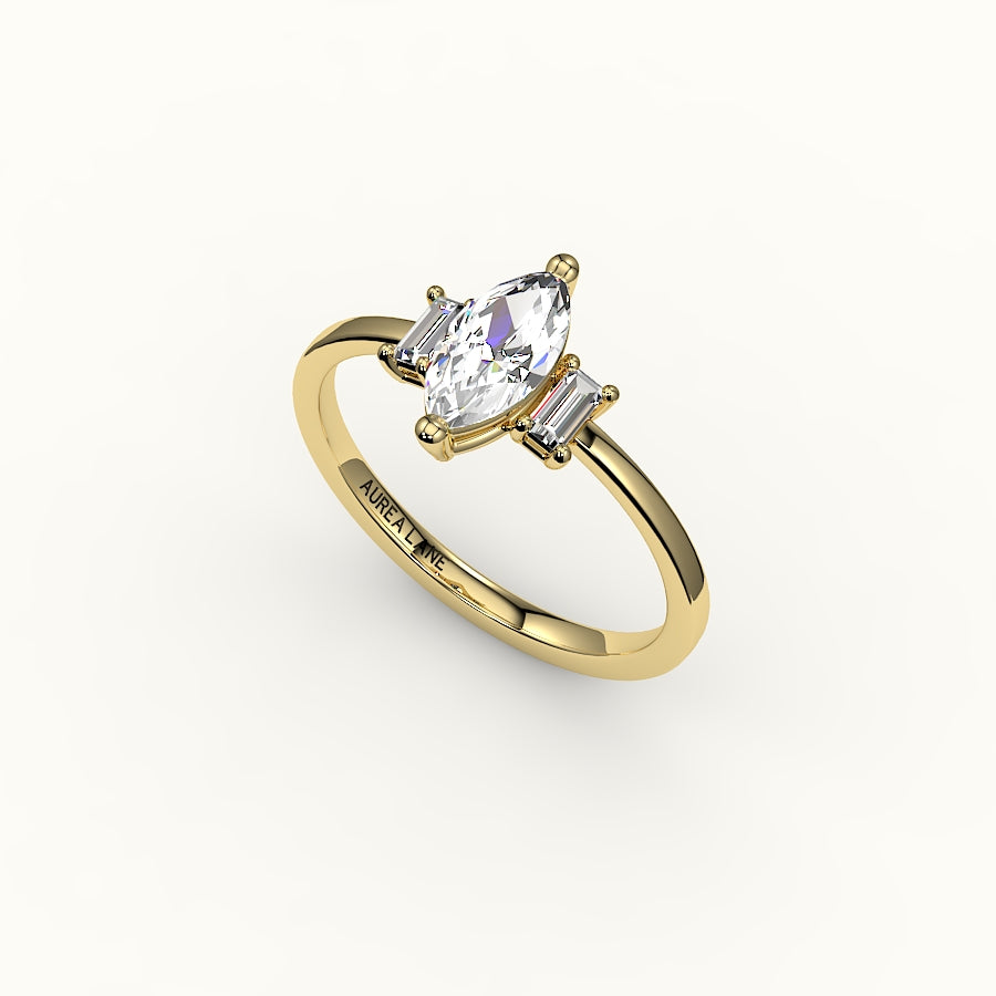 Engaste de tres piedras con talla marquesa y baguettes verticales