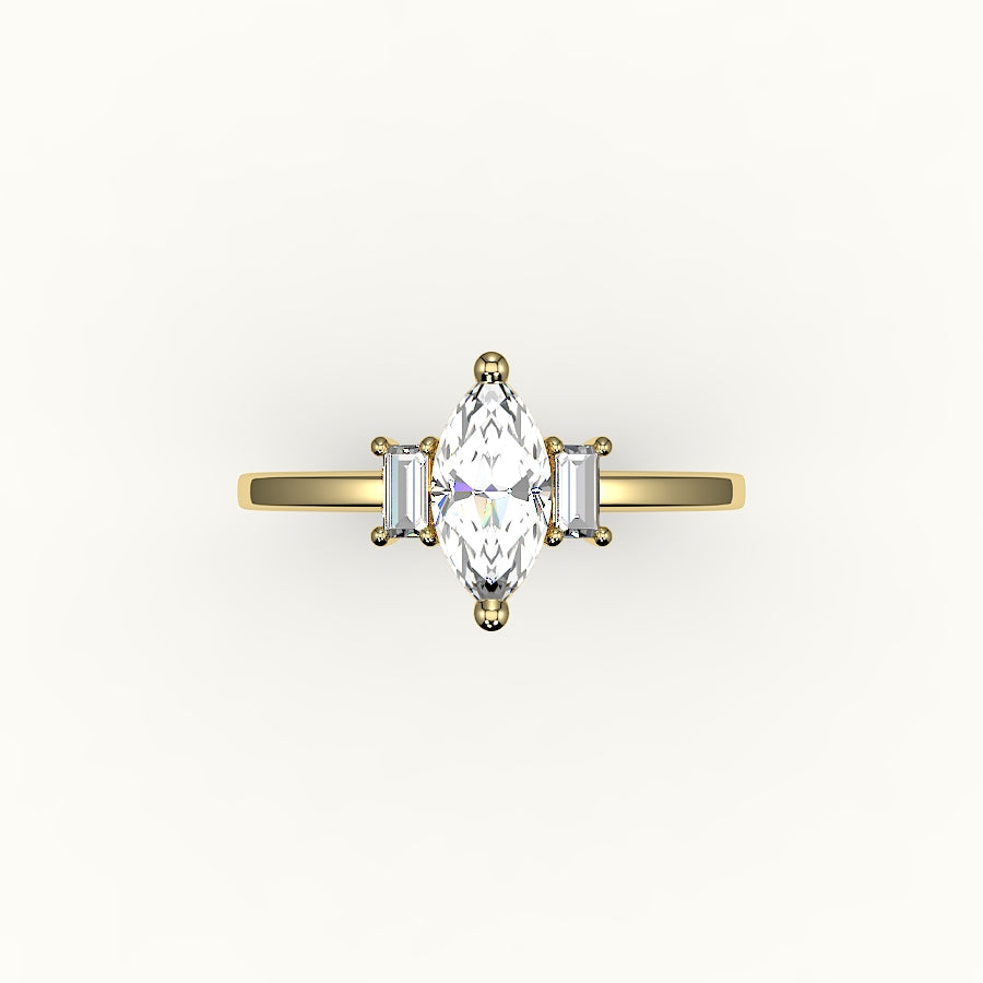 Engaste de tres piedras con talla marquesa y baguettes verticales