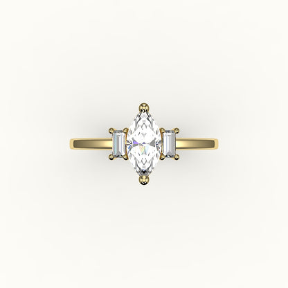 Engaste de tres piedras con talla marquesa y baguettes verticales