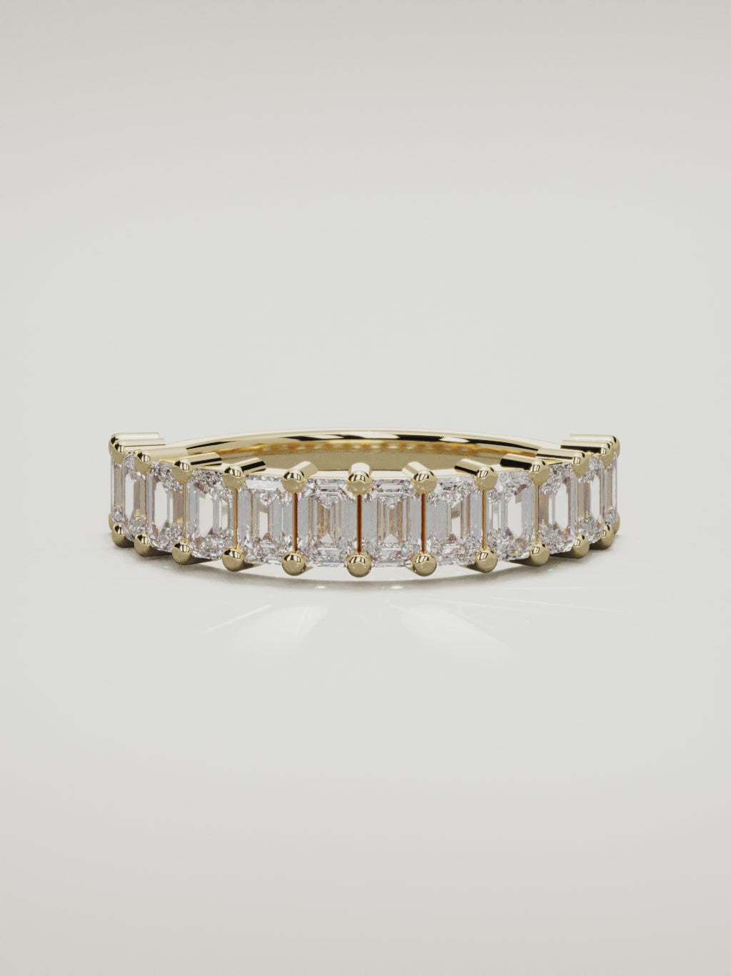 The Gracia prong emerald-cut half eternity band in 14K yellow gold, 360 turntable video