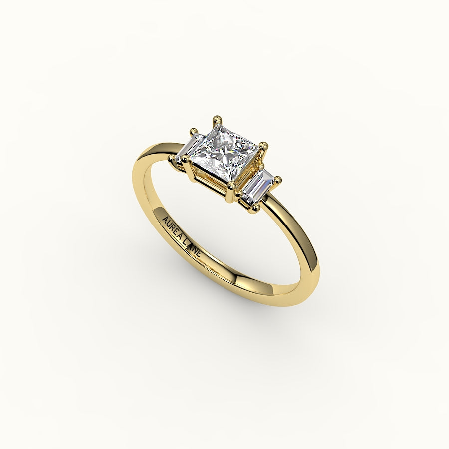 Engaste de tres piedras de corte princesa con baguettes verticales