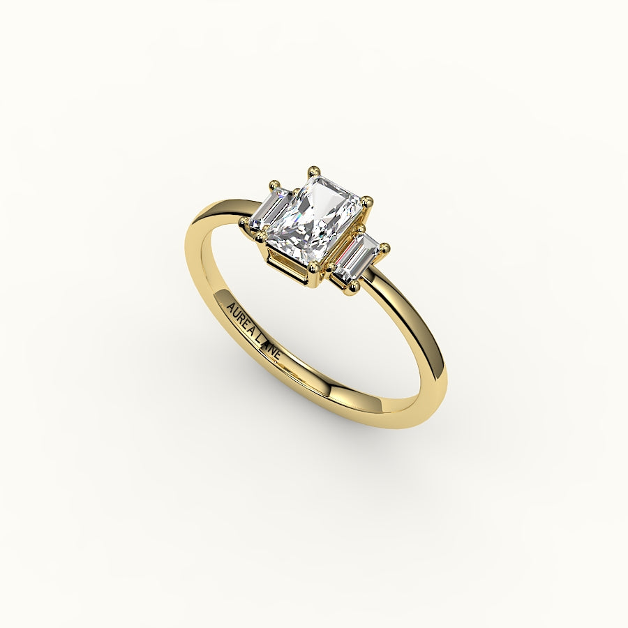 Engaste de tres piedras con corte radiante y baguettes verticales